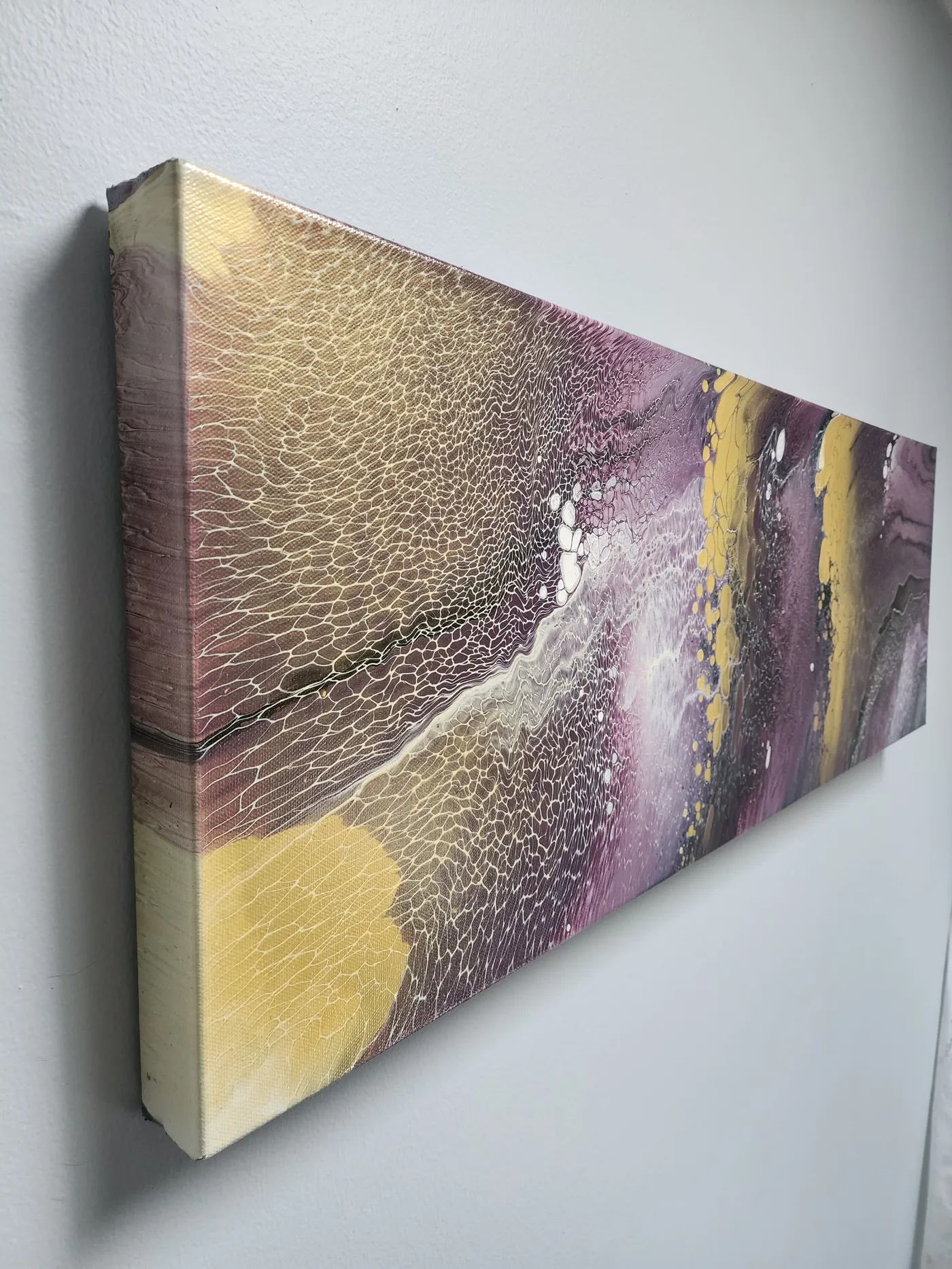 An angled view of the fluid art piece, showcasing both its width and the detail wrapping the edge of the canvas.