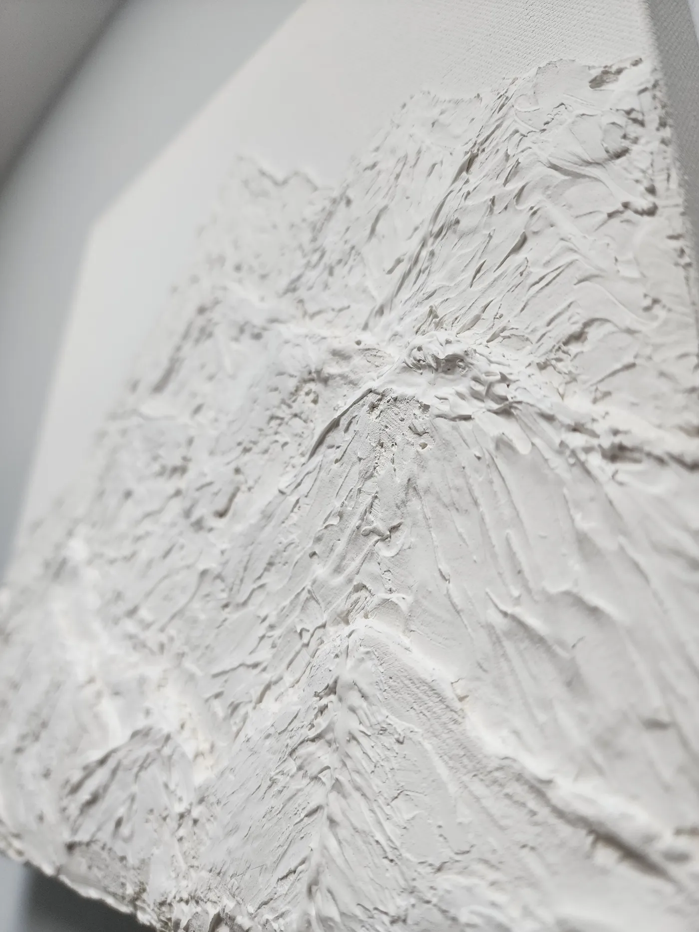 An angled shot of the plaster mountain piece from below showcasing the shadows of different lighting angles on the 3D design.