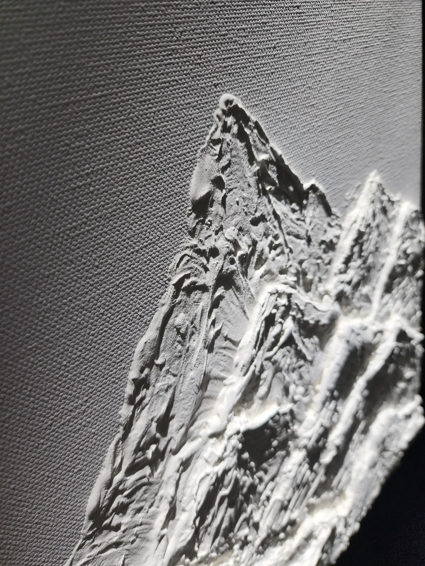 An up-close shot of the plaster mountain peak showcasing the shadows of different lighting angles on the 3D design.