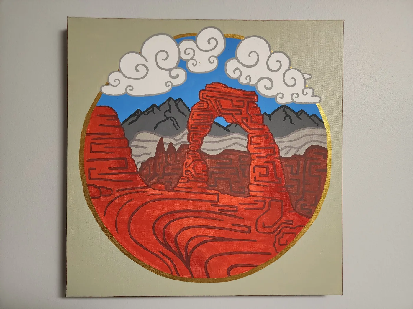 Canvas painting of Delicate Arch in Arches National Park hanging on a neutral colored wall.