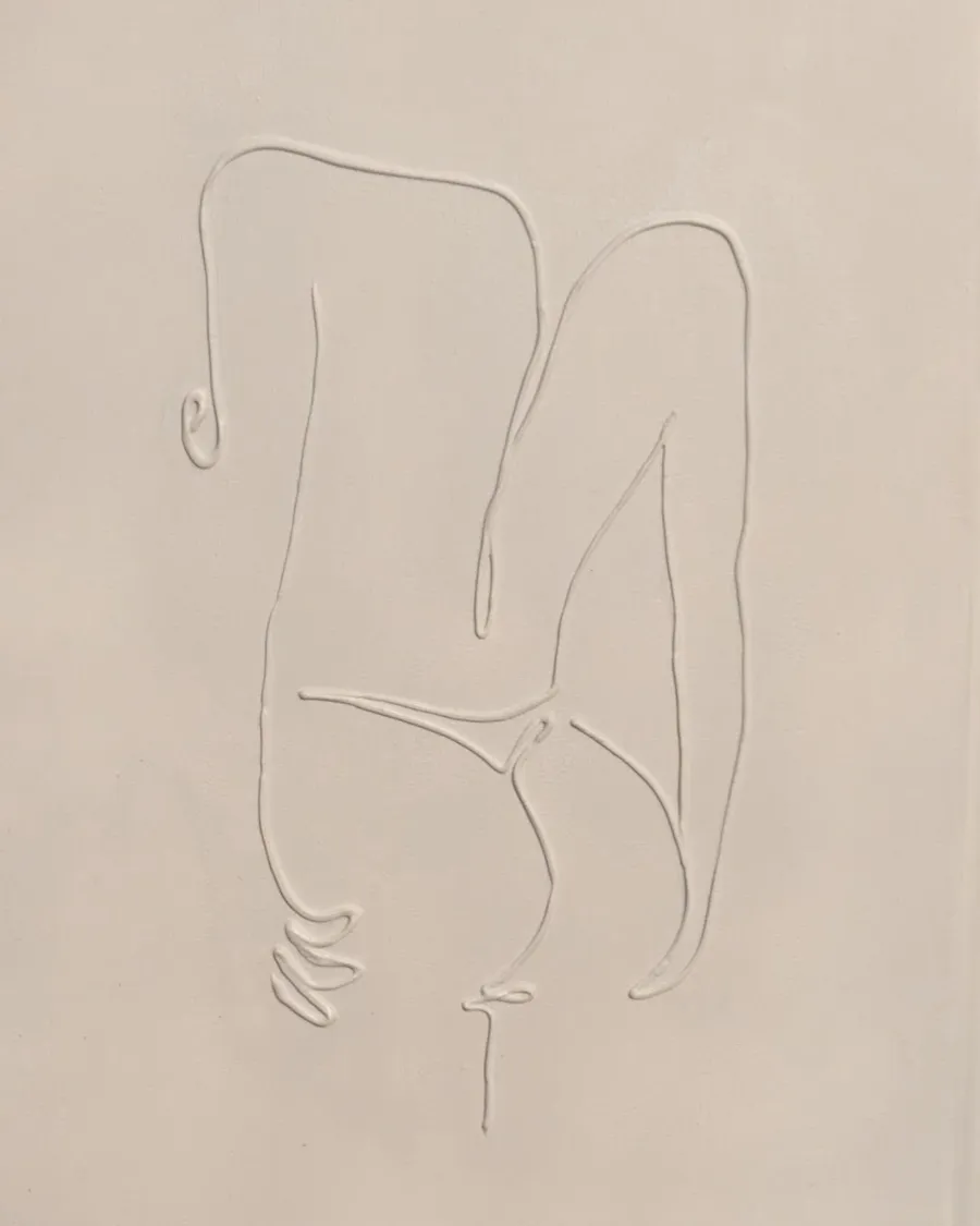 Cream canvas with a raised plaster line drawing of a seated figure, drawn as a single continuous contour.