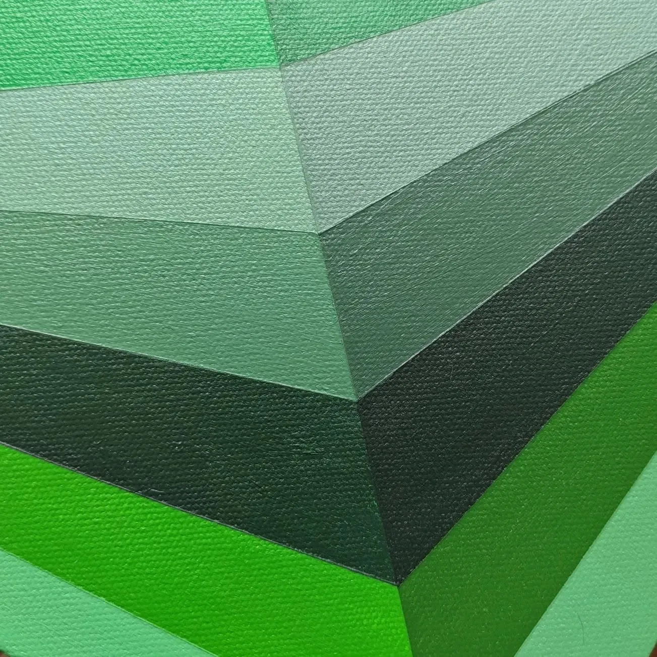 Close view of the green facets meeting at a point, canvas texture visible through the paint.