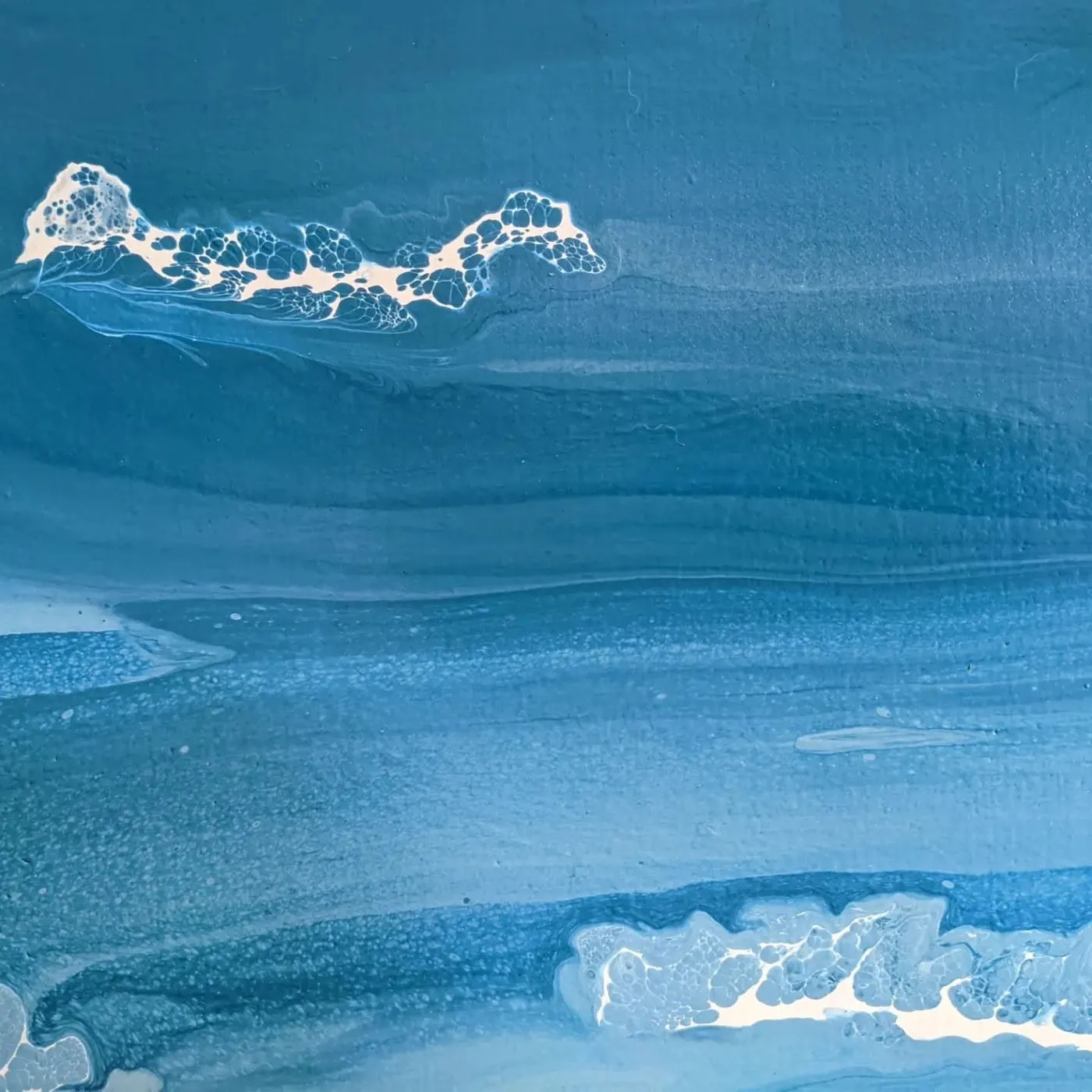 Detail of the painted water, white foam cells breaking across layered blues.